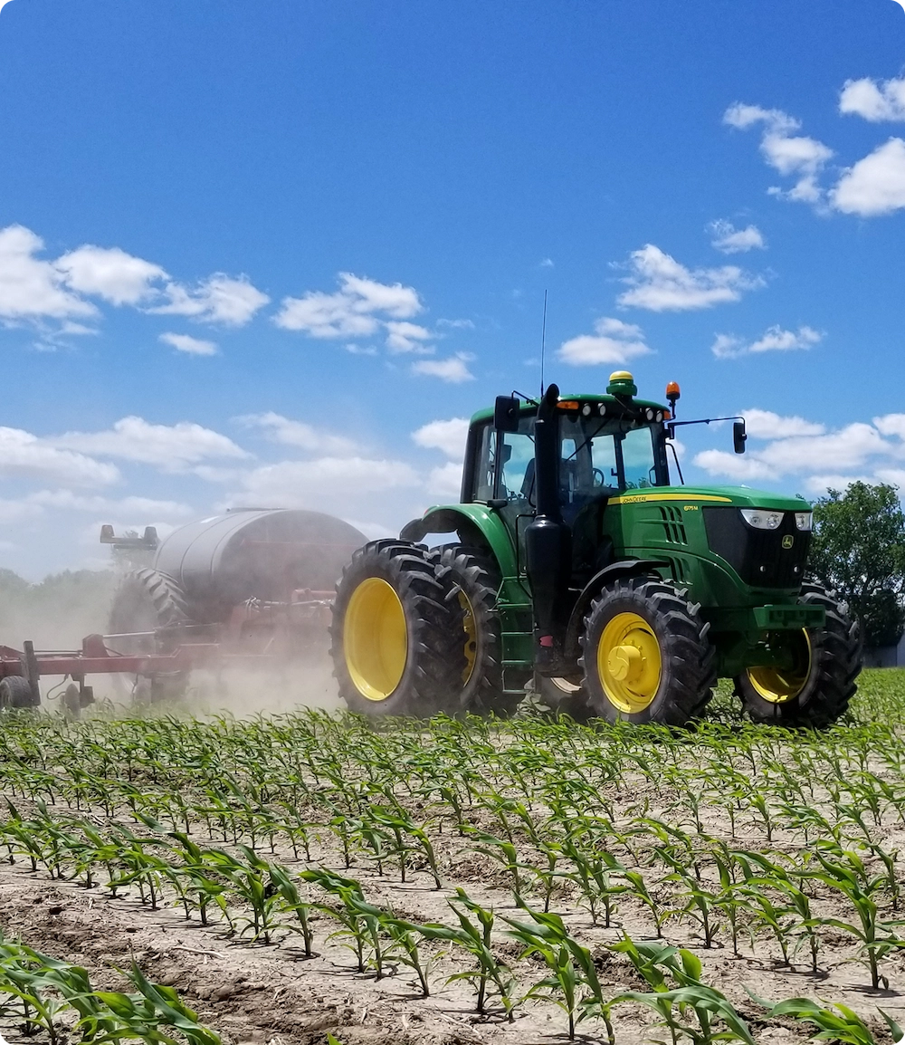Modern tractor working in a crop field, supporting farmers and agricultural operations